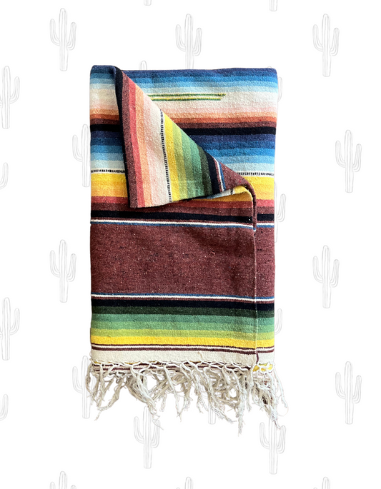 top view image of mexican throw blanket folded up on light background.