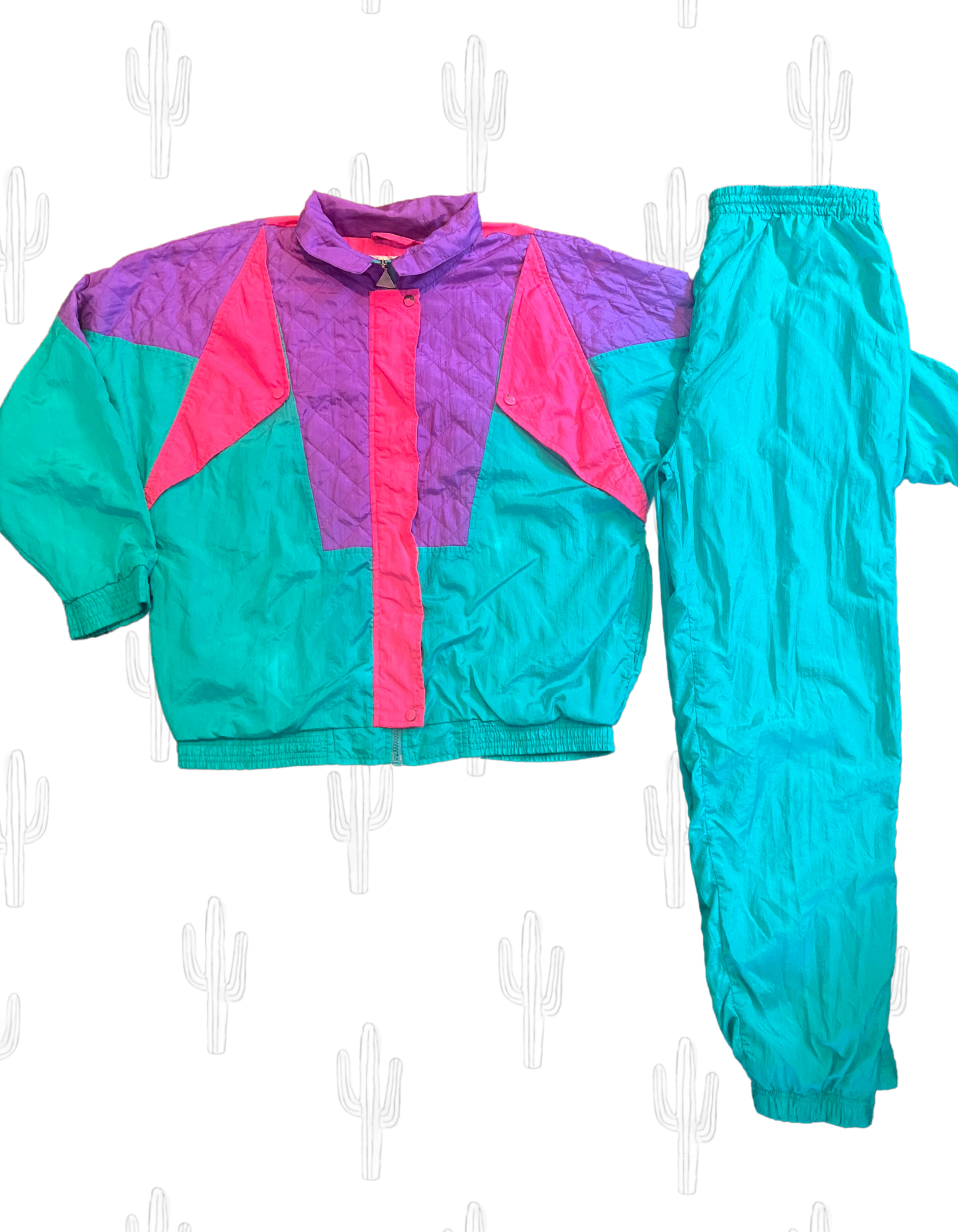 Front image of teal, purple and hot pink color pop windsuit featuring jacket and pants on white background.