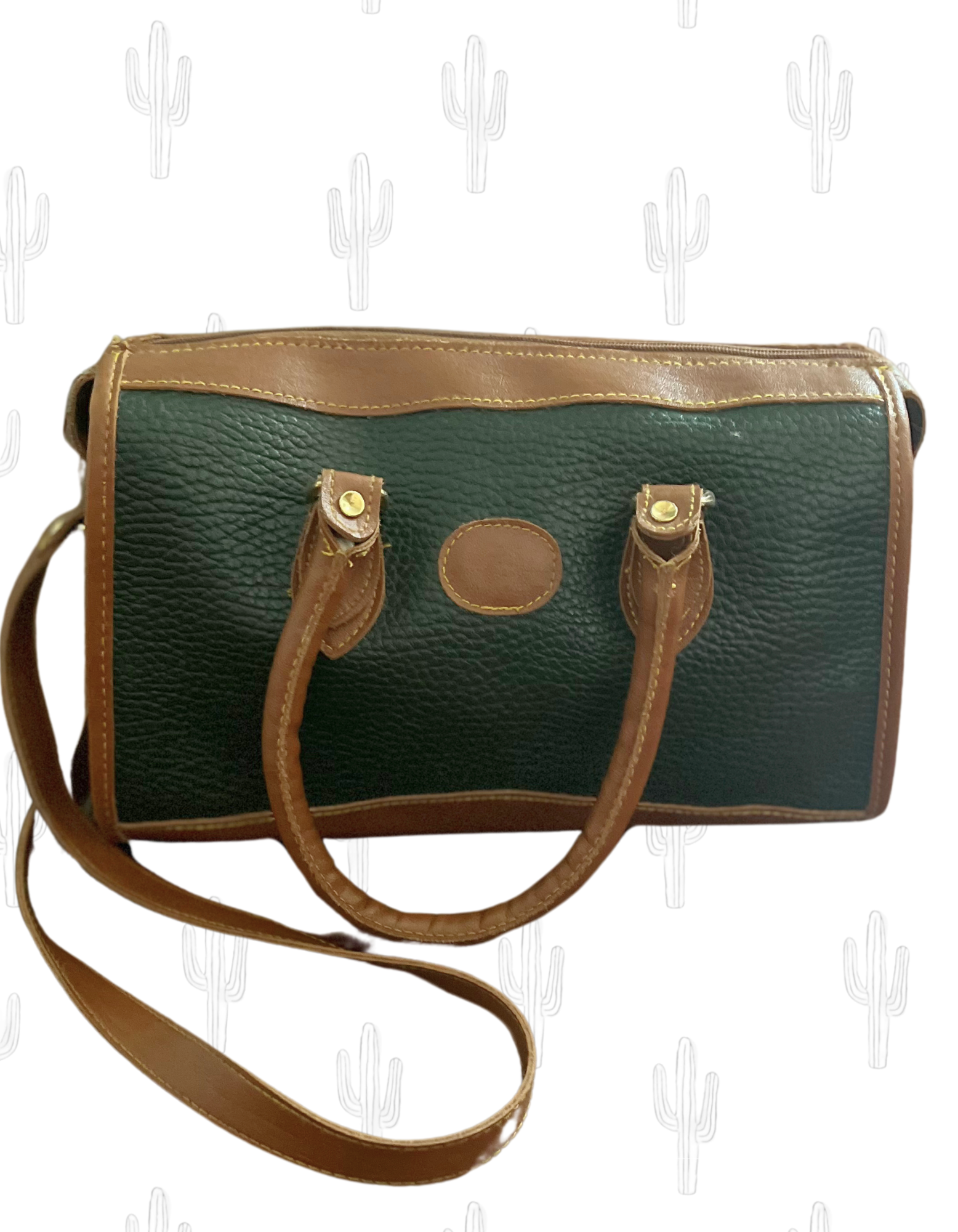 Front image of green and tan shoulder bag on white background.