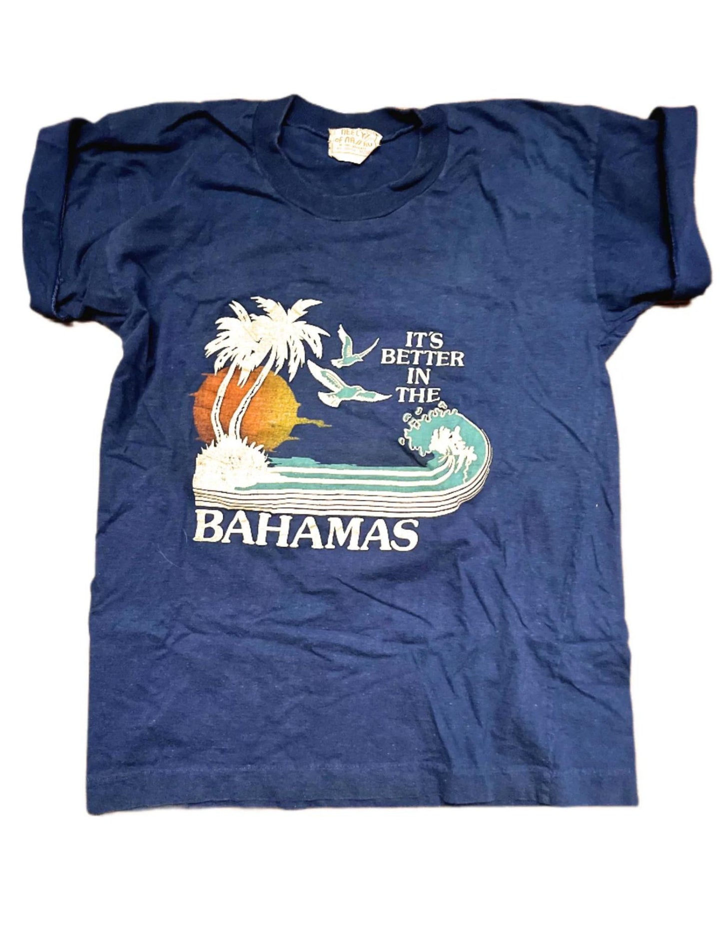 Front of blue t-shirt with 'its better in the Bahamas' graphic on white background.