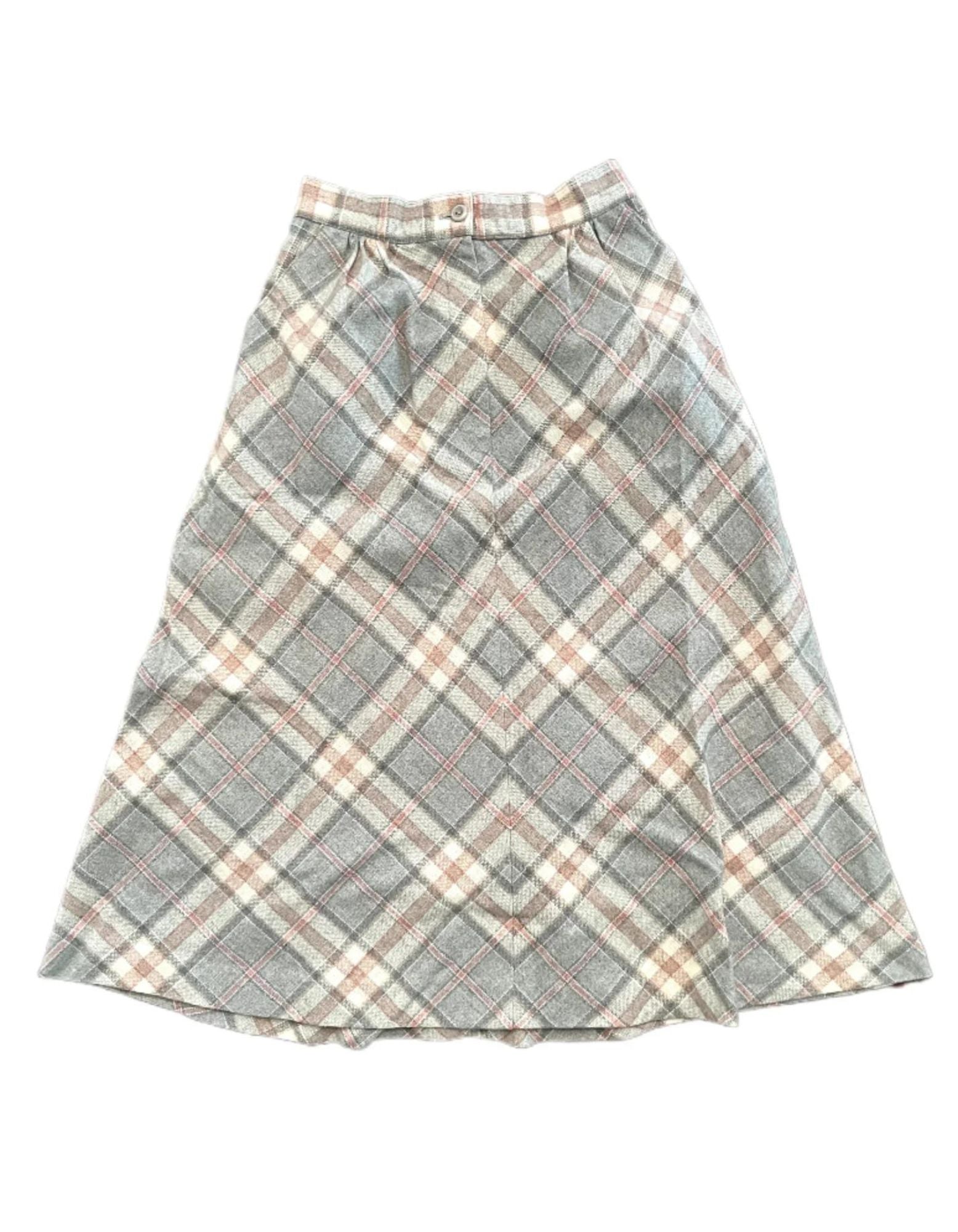 Vintage ladies 7/8ths plaid skirt in pink, grey and white with front zipper and button on white background.