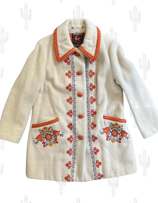 front image of Hooper cream coat with orange accents and embroidery on light background.