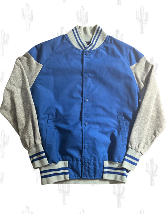 Front image of royal blue and gray bomber jacket on light background.