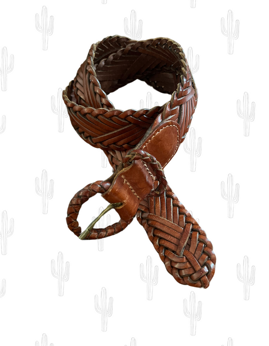 Front image of vintage brown leather woven belt made by eddie bauer on light background.