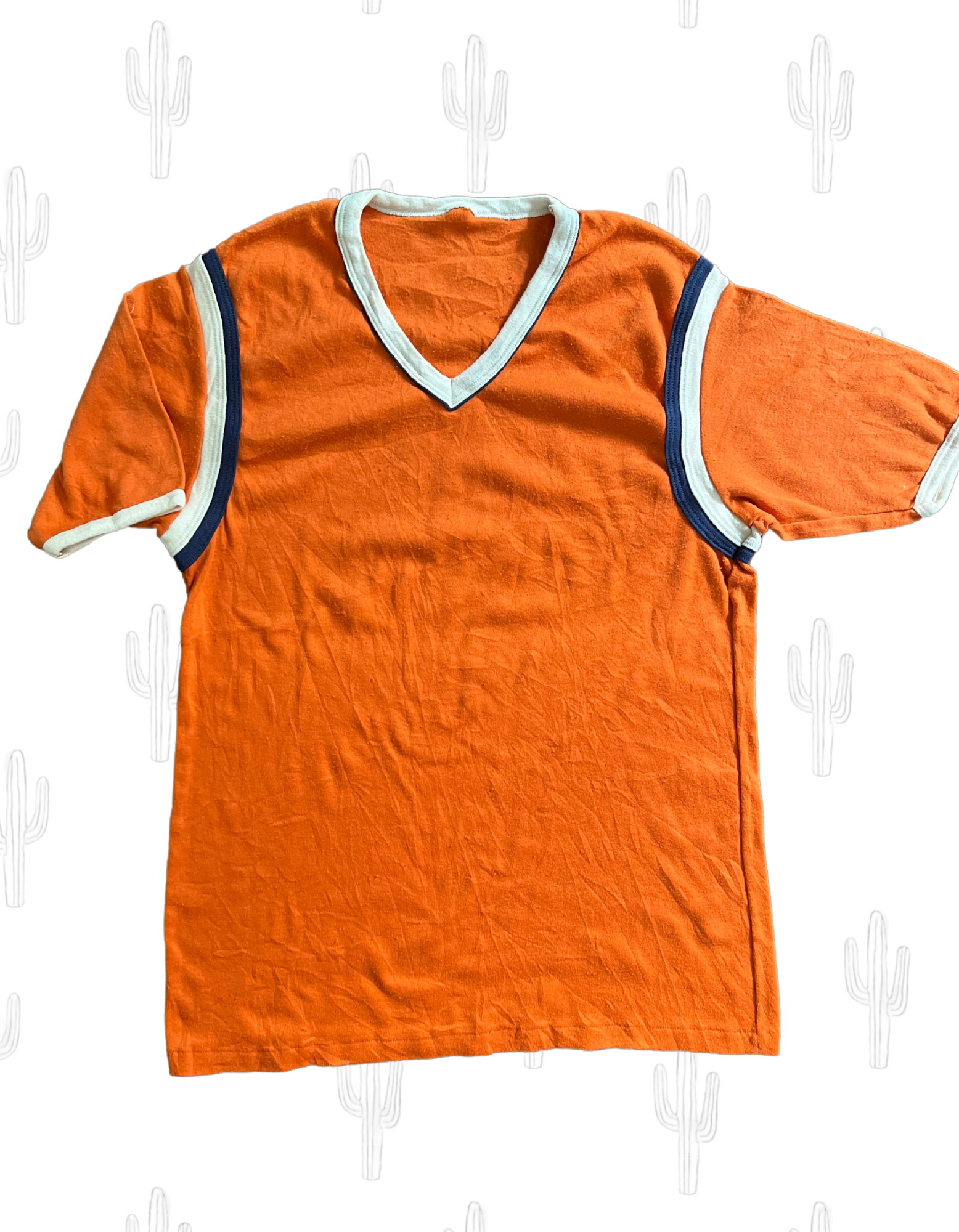 Front image of orange men's ringer tee with navy and white piping on light background.