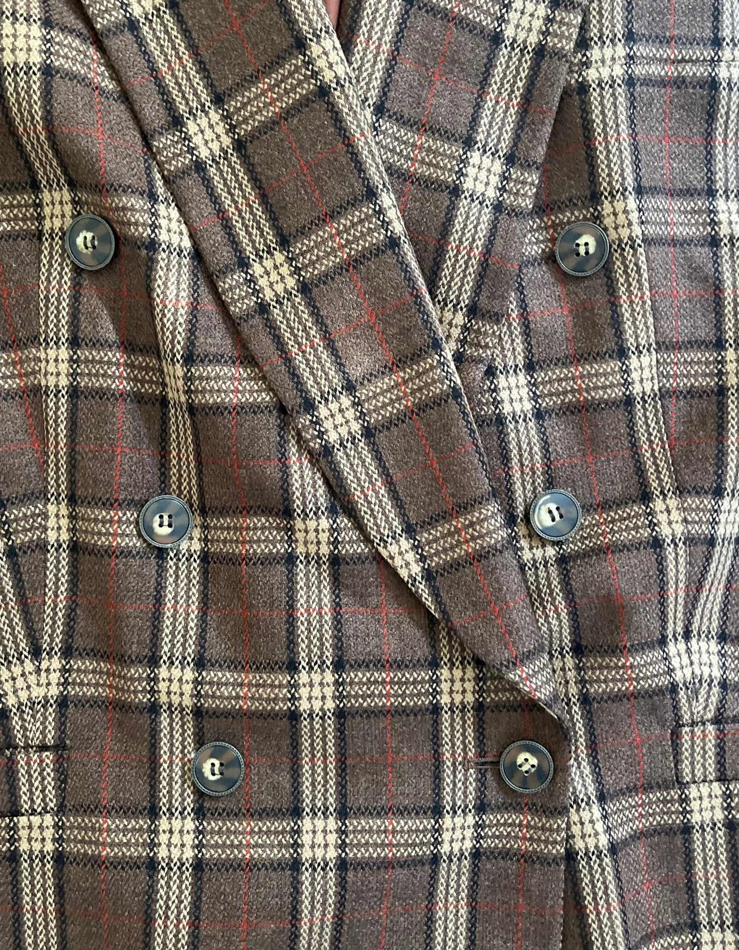 Close up image of vintage Evan-Picone plaid wool double breasted blazer on light background.