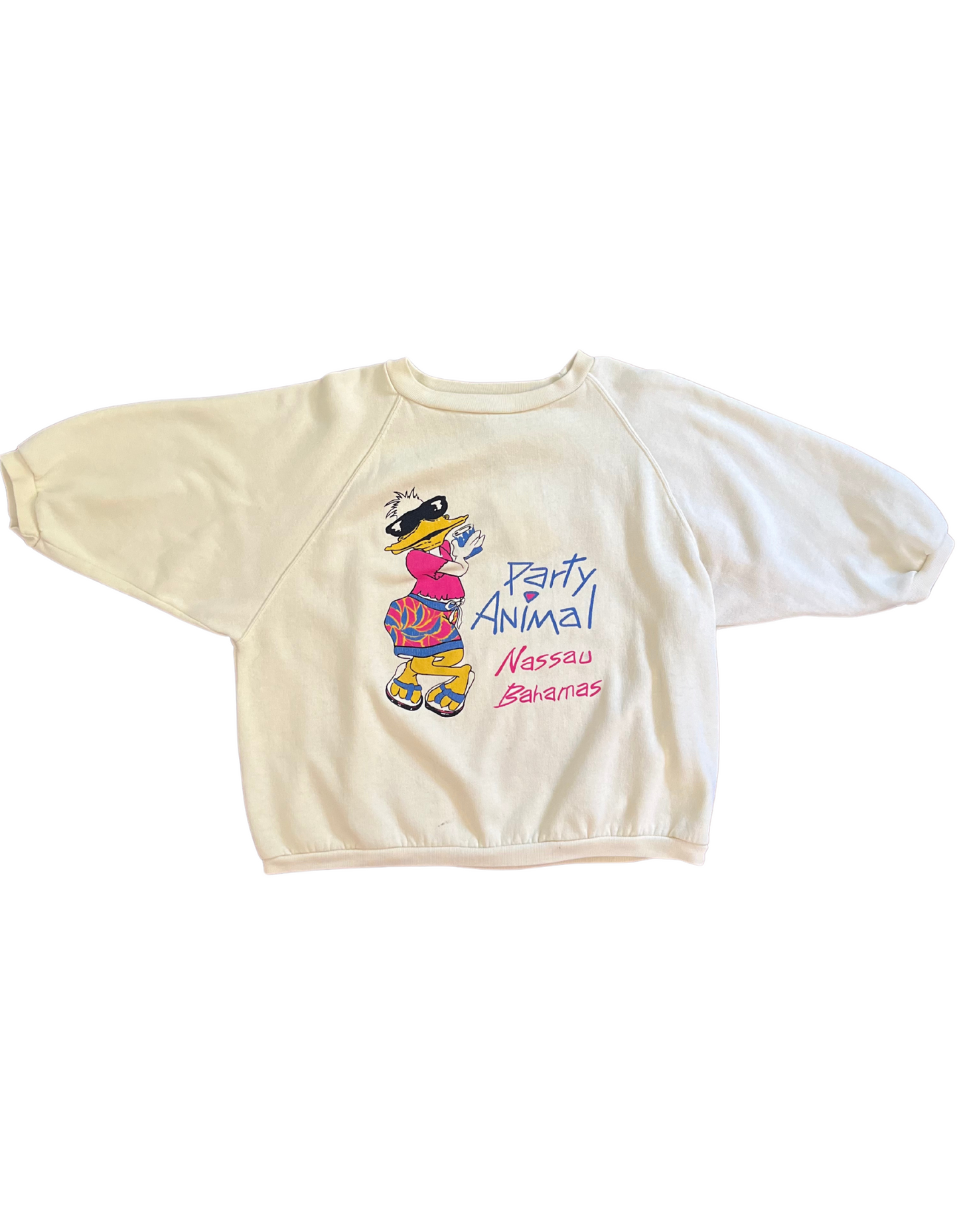 Entire Front image of light yellow sweatshirt that reads party animal, nassau bahamas featuring a duck wearing sunglasses on a white background.