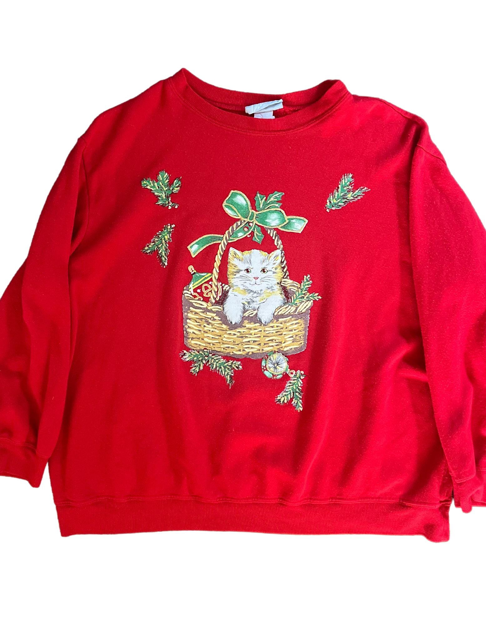 Front image of red christmas sweatshirt featuring kitty cat in basket on white background.