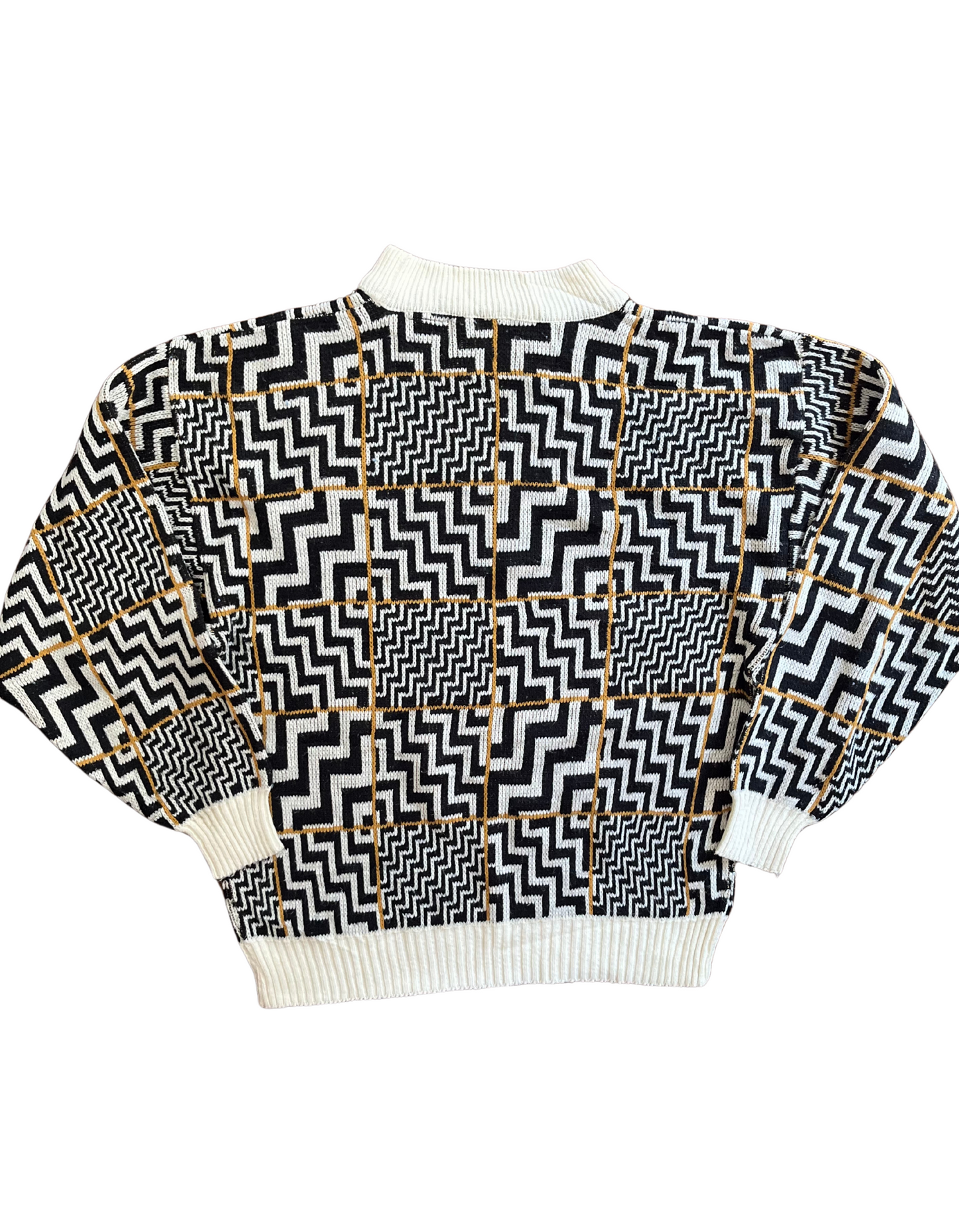 Back image of black and white zig zag sweater on white background.