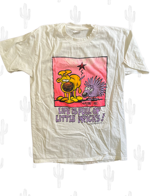 Front image of Mother Goose & Grimm comic tee featuring a dog and porcupine with text reading 'Life is full of little pricks!' on light background.