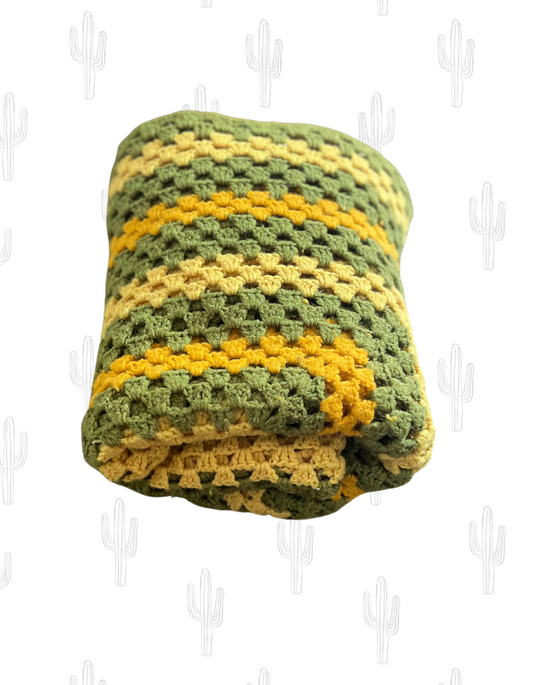 Front image of avocado and mustard granny square blanket on light background.