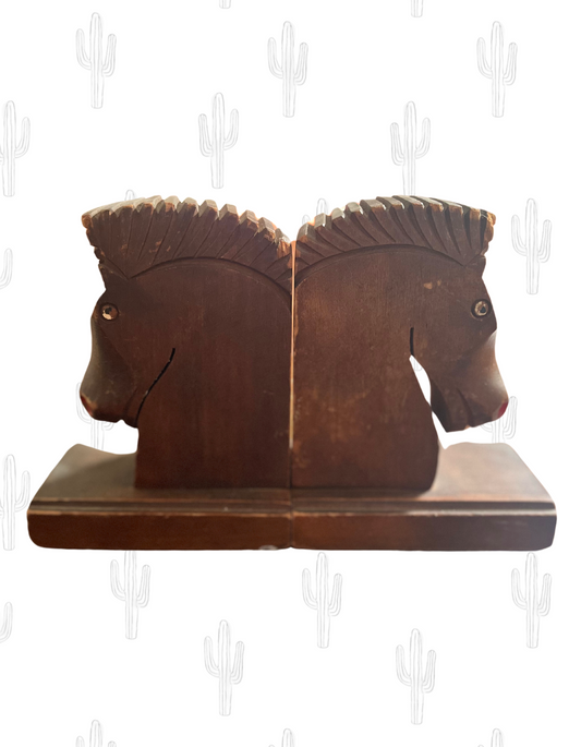 Front image of brown wooden horse head book ends on light background.