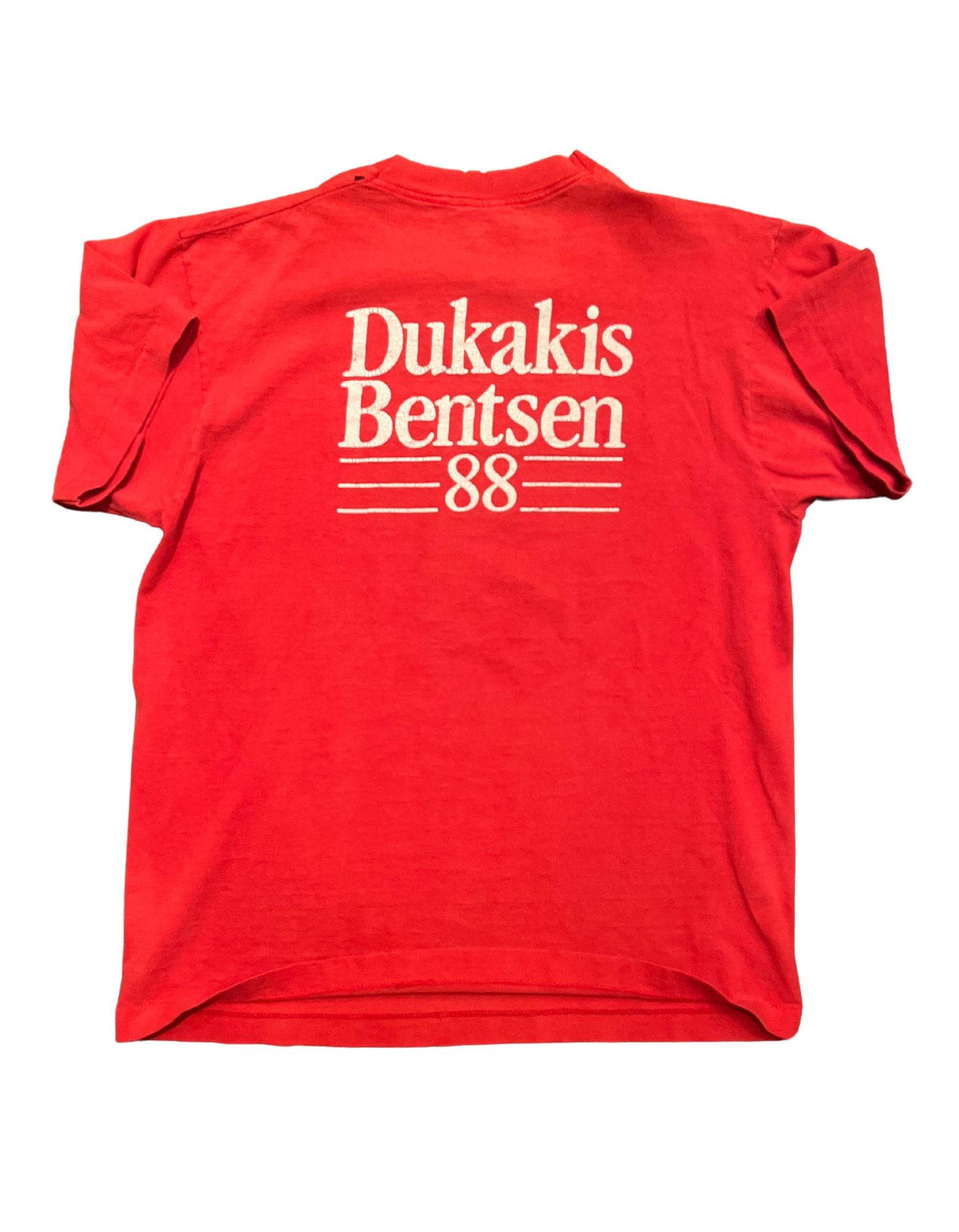 Back of red 1988 Dukacrat tshirt with white text on white background.