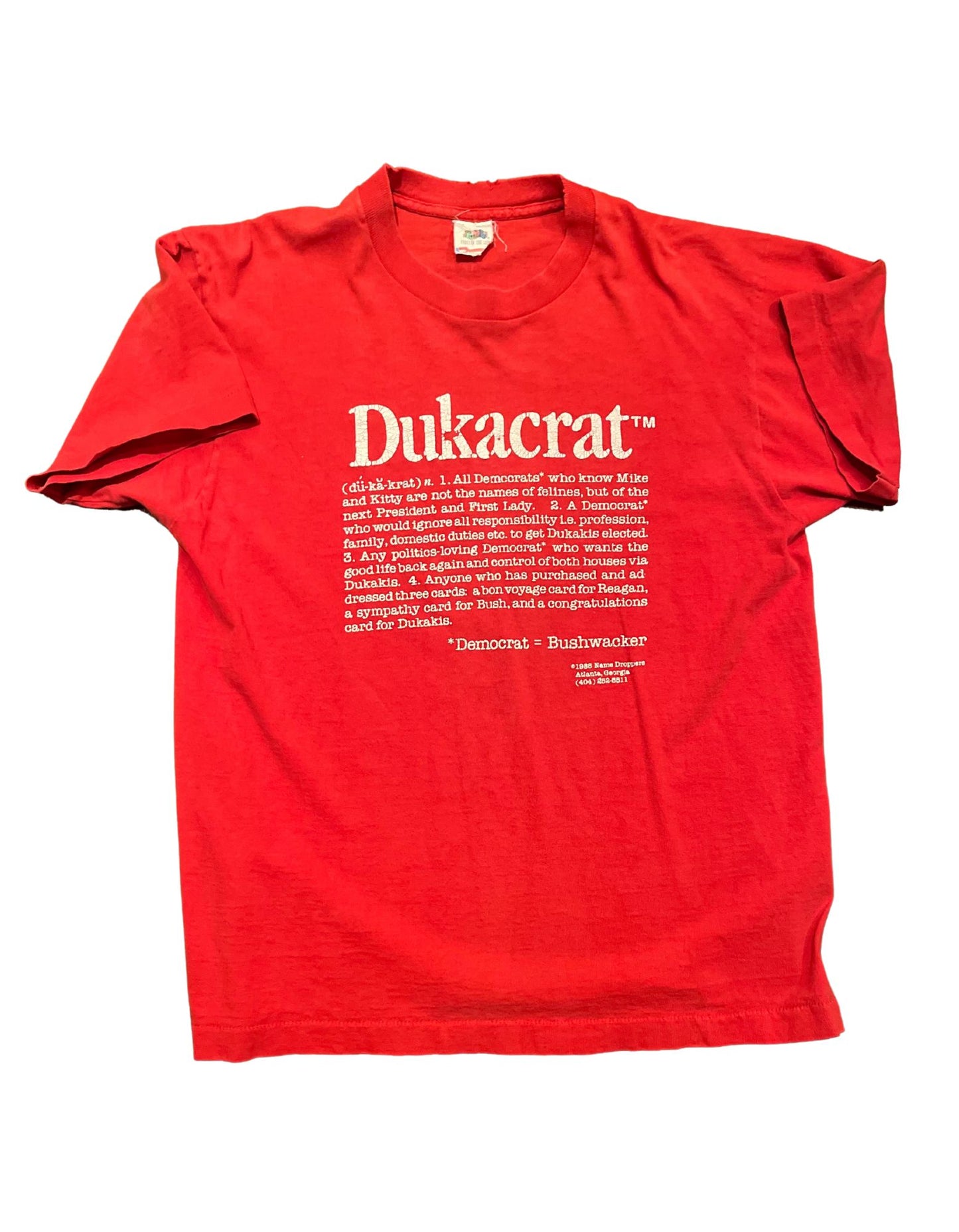 Front of red 1988 Dukacrat tshirt with white text on white background.