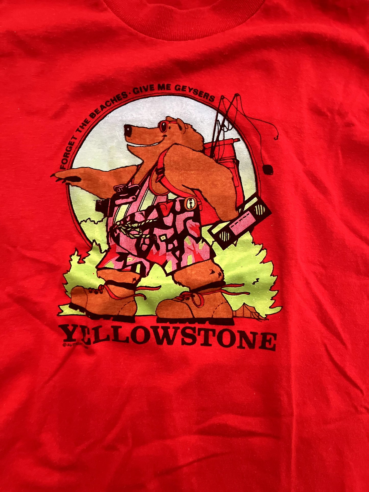 Image of red youth Yellowstone graphic t-shirt with camping bear on white background close up shot of graphic.